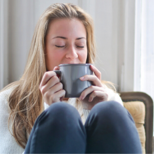 woman drinking from coffee mug